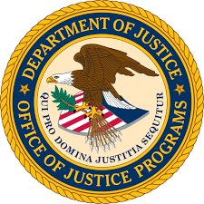 Seal of the U.S. Department of Justice, Office of Justice Programs, featuring an eagle, shield, and Latin motto. Represents justice initiatives.